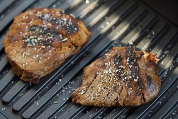 Tasty fresh grilled meats with spices and salt