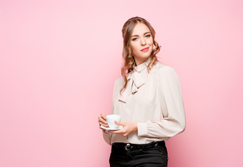 The serious frustrated young beautiful business woman on pink background