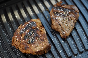 Tasty fresh grilled meats with spices and salt