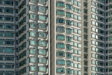 Fototapeta na wymiar Highrise residential building in Hong Kong city. The many windows in the building Hongkong.