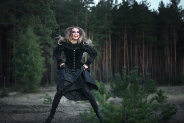 Fototapeta na wymiar beautiful girl in a black dress in the forest.