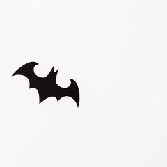 Handmade black bat on white background. Flat lay, top view. Halloween concept