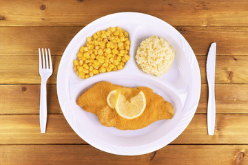 Battered fish tv dinner on wooden background, top view.