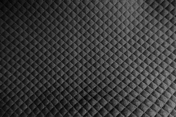 Surface of black fabric with embossed squares