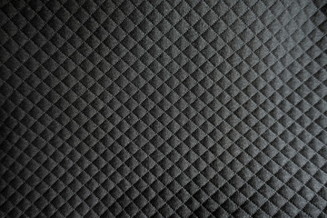 Relief checks pattern on black polyester fabric
