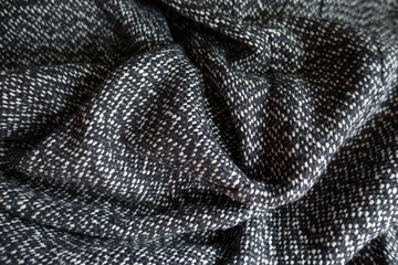 Folded salt and pepper woolen tweed fabric