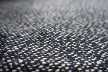 Macro of tweed woven from black, white and blue threads