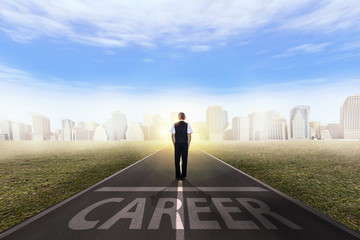 Back view of a businessman standing on the road and ready to chase his success.