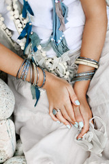 Obraz premium close up of boho styled woman hands with silver jewelry