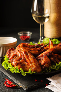 Grilled chicken wings with glass of wine