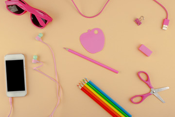 Still life, office accessories or the concept of education: top view on a light beige background