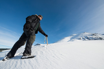 Fototapeta na wymiar climber with an ice ax in the snowy mountains