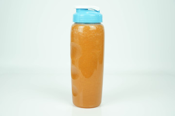 healthy juice, carrot smoothies in platic bottle isolated on white background, clean drink, diet menu, fitness drink concept