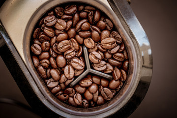 Coffee bean grain in a grind machine on black background