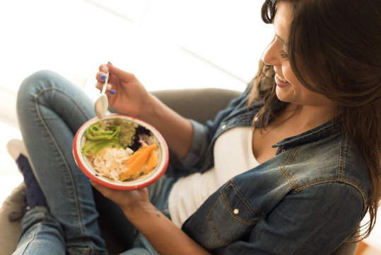 Woman eating a healthy bowl of superfoods