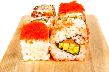 Sushi set roll on wooden board isolated on white background with reflection.