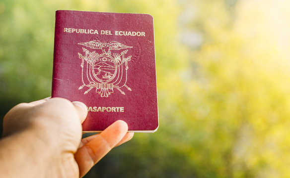 Someone holding a passport from the Republic of Ecuador, isolated. Ecuador is in South America