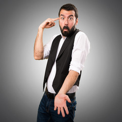 Cool man making crazy gesture on grey background