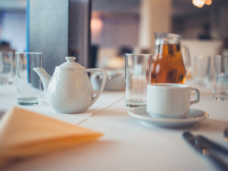 Teapot and cup on table