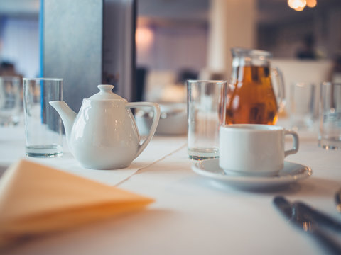 Teapot and cup on table