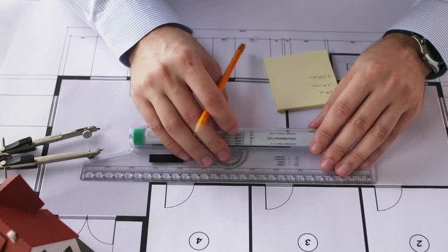architect hands with ruler measuring blueprint