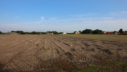 Fototapeta na wymiar field plowed with dry ground in the Dutch plain