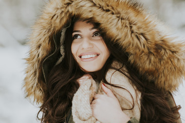 Pretty young woman in the park on the winter day