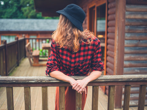 Woman wearing hat relaxing on porch