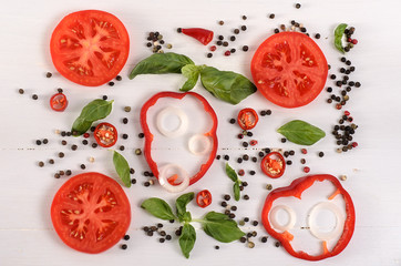 Vegetables background. Tomatoes, basil and garlic on white wooden table. Food background 