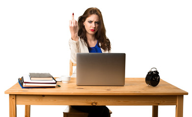 Business woman working with her laptop and making horn gesture