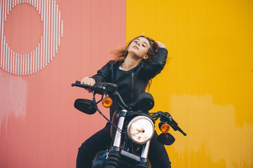 Pretty girl poses with motorcycle