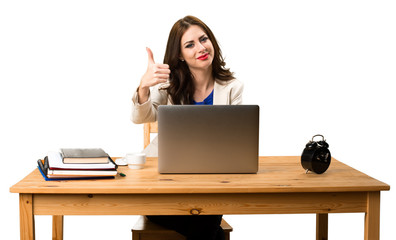 Business woman working with her laptop and with thumb up
