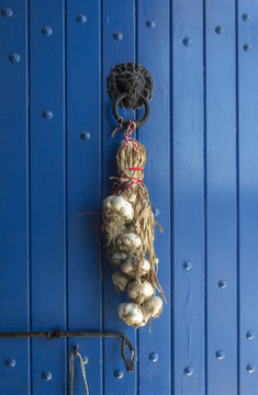 garlic braid on a blue door