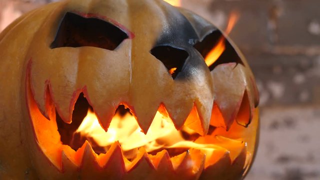 Halloween. Burning pumpkin. Side view.