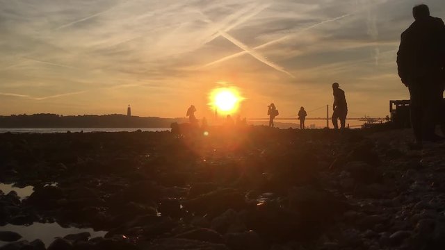 Time Lapse Amazing Sunset In Tagus River, People Play In Low Tide. Amazing Sunset In Lisbon, the capital and the largest city of Portugal.