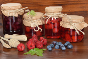 blueberries and raspberries in jars for the winter tea