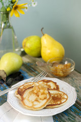 Pancake with pear compote, breakfast. Rustic style, selective focus.