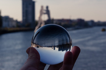 berlin skyline with molecule man monument shot through a glass sphere