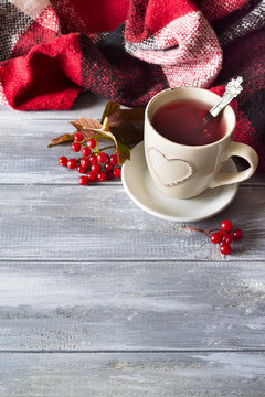 cup of hot tea with viburnum berries