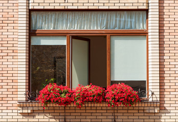 window decorated with flowers in a brick house