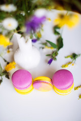 Symbol heart of flowers and macaroons on the light background. Top view. Text I love you