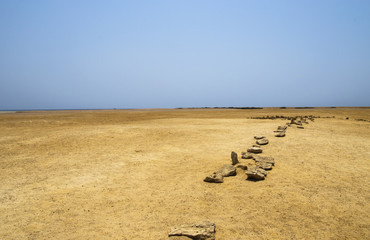 Landscape of the sandy desert with a line of stones. Ras Mohammed National Park