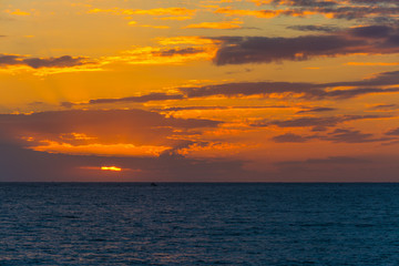 Dark clouds over the sea at sunset