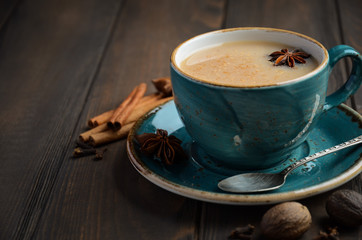 Indian masala chai tea. Spiced tea with milk on dark  wooden background. - obrazy, fototapety, plakaty