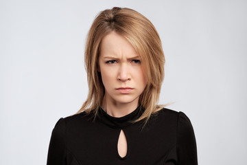 portrait of young serious angry woman with blond hair
