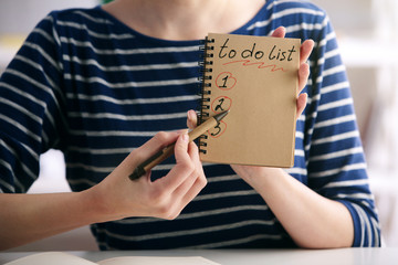 Female writing to do list