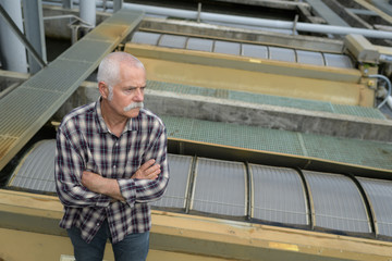 Fototapeta premium senior worker at roof of an unfinished house