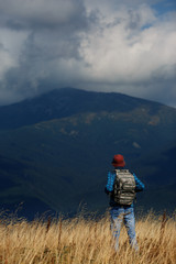 Fototapeta na wymiar Hiking man in the mountains. Stormy weather