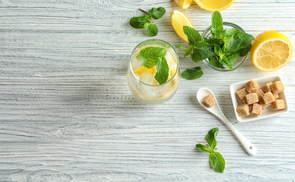 Composition with ingredients for mojito on wooden background