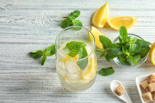 Composition with ingredients for mojito on wooden background